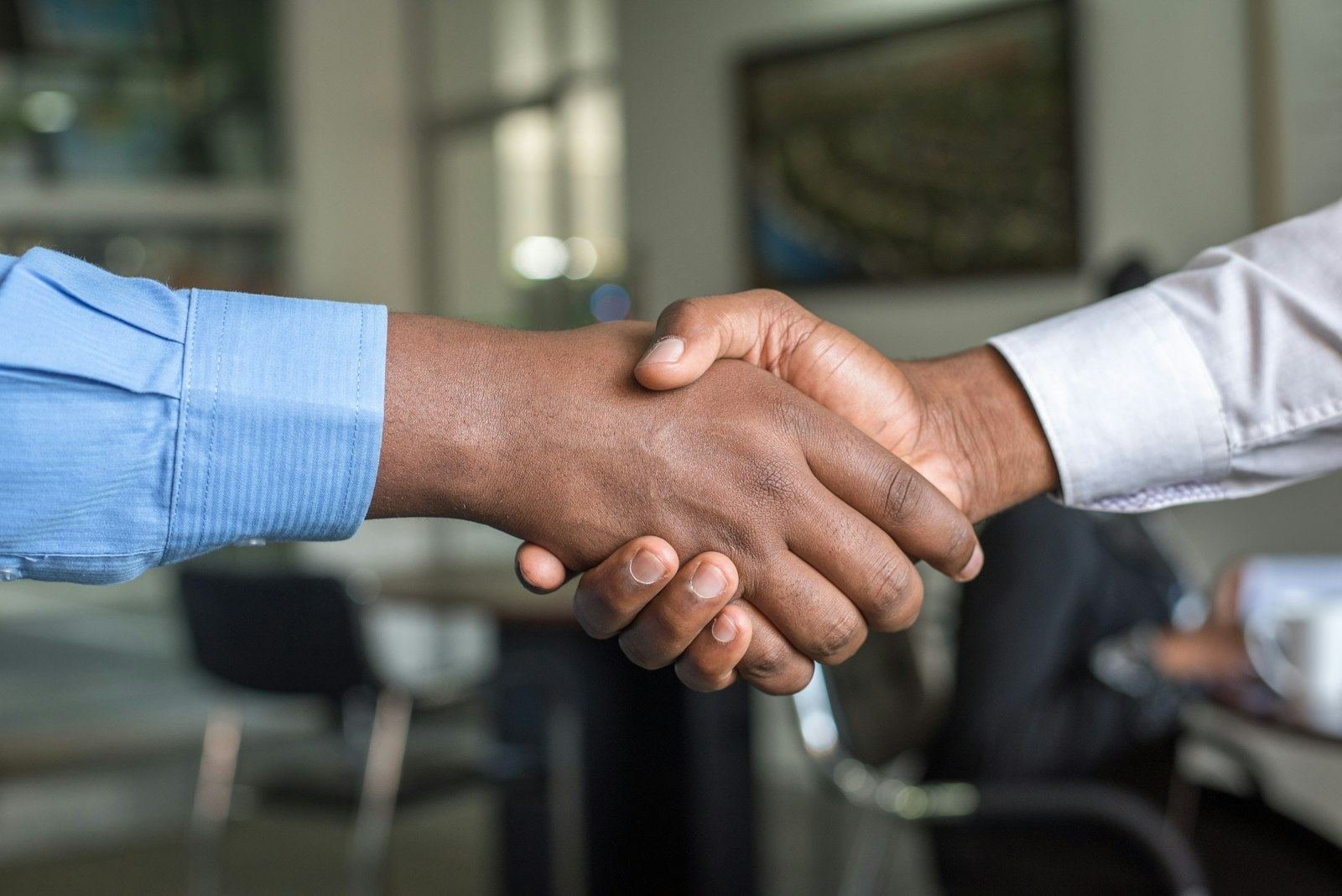 Two professionals shaking hands in an office